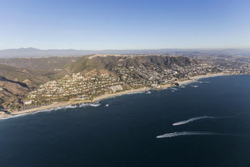 Aerial view of passing boats along the pacific coast near Laguna Beach in Orange County California.  