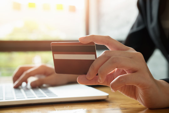 asian young business woman hands holding credit card and using laptop smart phone Online shopping.Online shopping concept