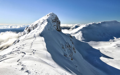 Footsteps lead along the narrow summit ridge of Mt. Ruapehu in New Zealand.