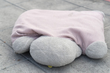 An abandoned doll on the ground