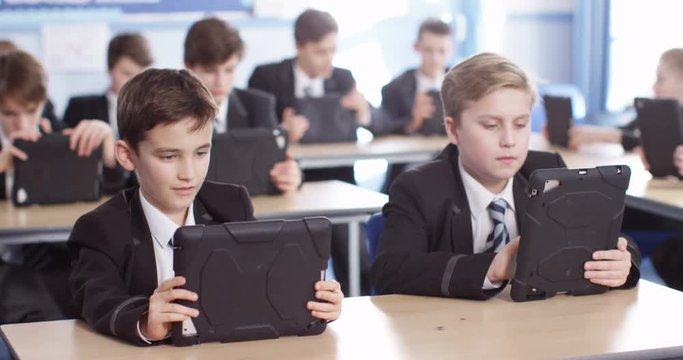 4k, Row of private high school students work on a digital touchscreen tablet in class.Slow motion.