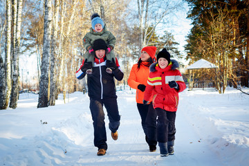 Family of four enjoying in winter park
