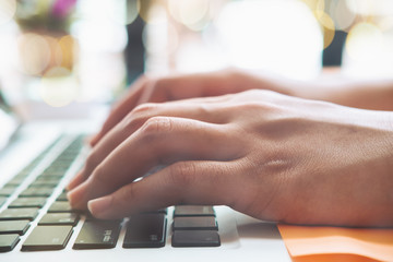 Business woman hand using laptop with social network working at home office. Close up hand on keyboard.