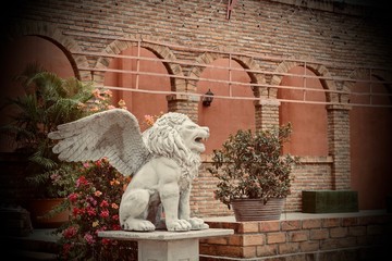 Statue of a beautiful white lion in the garden.