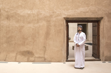 arab man in traditional omani outfit in an old castle