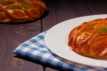 Bun with kiwi jam on white plate