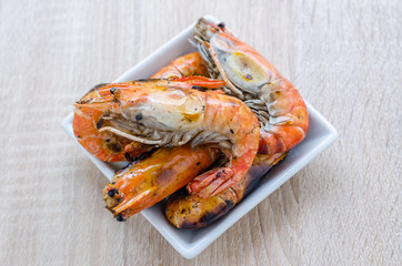 Thai style barbecue, grilled shrimp on wooden background