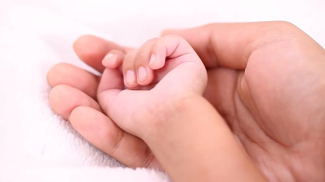 Mother and baby hands together