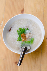 Congee with minced pork in white bowl, breakfast time