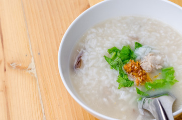 Congee with minced pork in white bowl, breakfast time