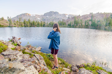 Fototapeta na wymiar Girl Looking at Mountain Lake