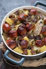 Closeup of Irish coddle or sausage, bacon, onion and potato hotpot, selective focus, studio shot