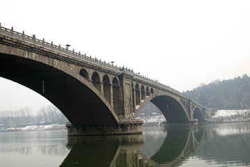 Fototapeta na wymiar Old bridge and with White mist background