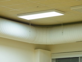 Fluorescent Light Fixture on a White Ceiling in warehouse