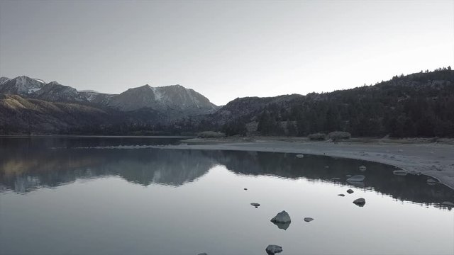Dramatic Grey Scale Aerial Reveal Lake June with reflection of Mountain background, Mono County - California 19
