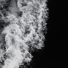 Beautiful sea wave with water spray and foam, photographed from aboard of a sailing yacht. Top view. Bw.