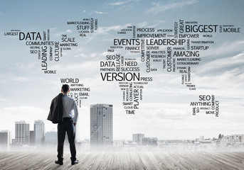 Motivation and inspiration concept with modern cityscape and businessman observing it