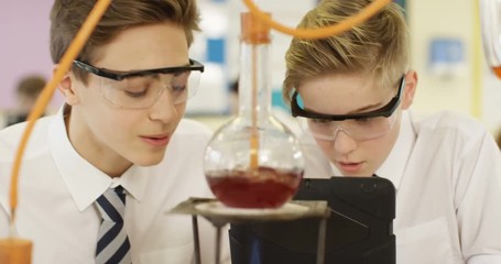 4k, Excited high school students doing science experiment in school laboratory.