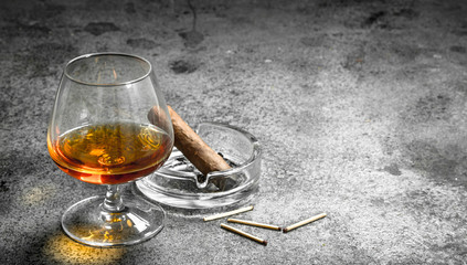 glass of cognac with a cigar.