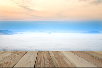 Mountainous landscape with golden skies and beautiful mist with wood space.