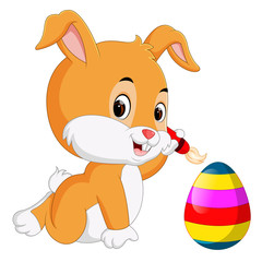 Cute Easter Bunny painting an egg 