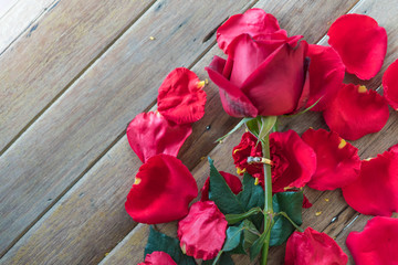 Fototapeta na wymiar Red rose flower on wooden floor in Valentine's Day