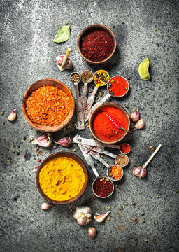 Various herbs and spices with measuring spoons.