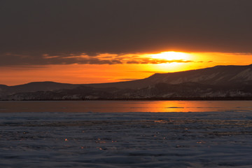 The reflection of sunset on winter lake Baikal	