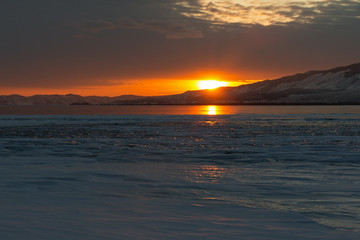 The reflection of sunset on winter lake Baikal