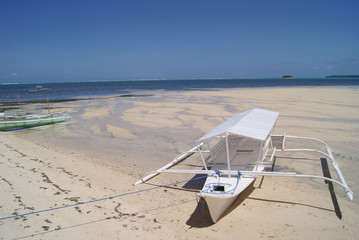 White Outrigger Moored on White Beach
