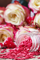 Red sweet heart, Valentines Day card on background of fresh pink and white roses, selective focus