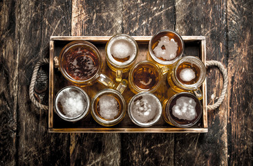 Glasses with fresh beer on an old tray.