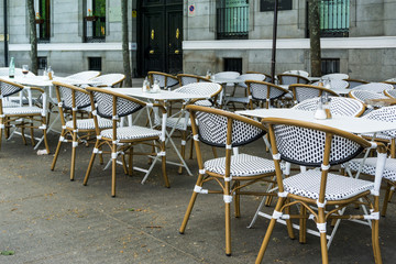 MADRID, SPAIN - April 20, 2017: Street view of a coffee terrace with tables and chairs in madrid