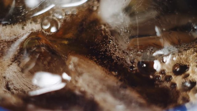 Bubbles of cola in ice. macroshot