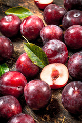 Fresh, ripe plums with leaves.