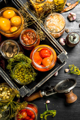 Preserved vegetables and mushrooms in a box with seamer.