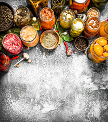 Marinated vegetables with spices in glass jars.