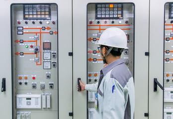 Engineer and 115kV control and protection panel at power plant