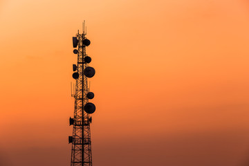 Obraz premium Communication towers as silhouettes in front a gorgeous sunset.