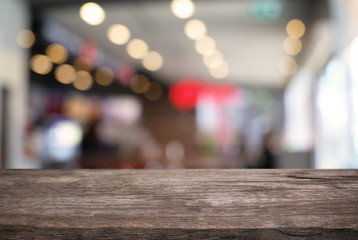 Empty wooden table in front of abstract blurred background of coffee shop . can be used for display or montage your products.Mock up for display of product.