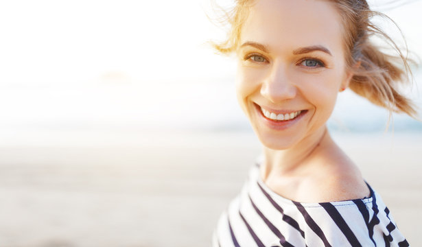 happy woman enjoying freedom and laughs on sea