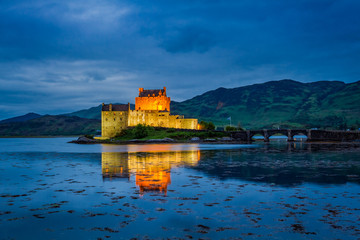 Dusk over loch at illuminated Eilean Donan Castle, Scotland