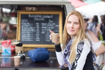 Fototapeta na wymiar young woman enjoying coffee in outdoor cafe