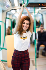 Smiling arab woman inside subway train