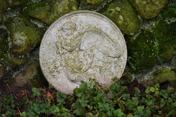 Weathered plate with a relief of Jesus Christ