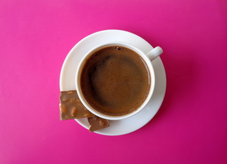 Coffee and chocolate, sweet pink background, top view of coffee cup