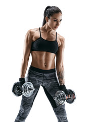 Young girl doing exercise with dumbbell as part of fitness workout. Photo of muscular girl isolated on white background. Strength and motivation
