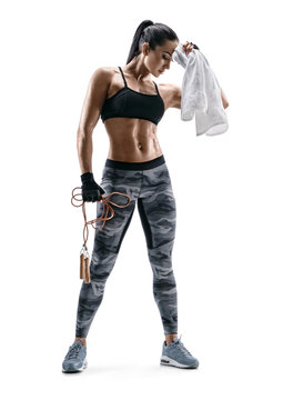 Fitness girl is resting. Sporty girl with skipping rope and towel in hands on white background. Strength and motivation