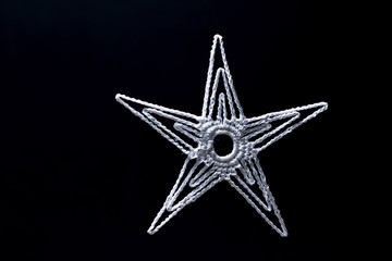 Snowflakes knitted white with black background.