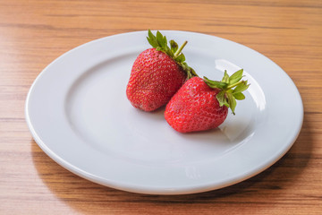 Fresh strawberry on a white plate